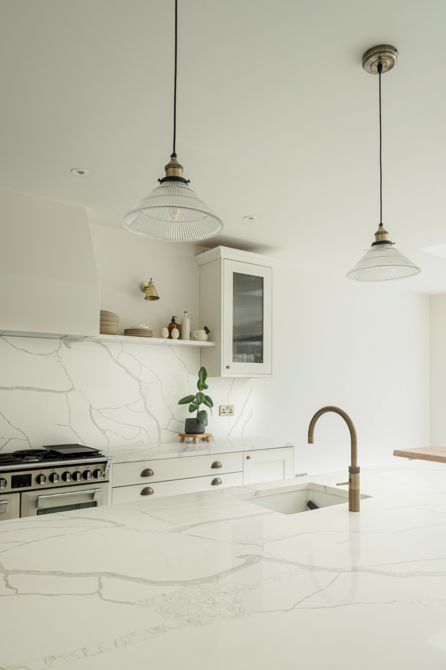 Calacatta Venato worktops in a light, minimalist kitchen