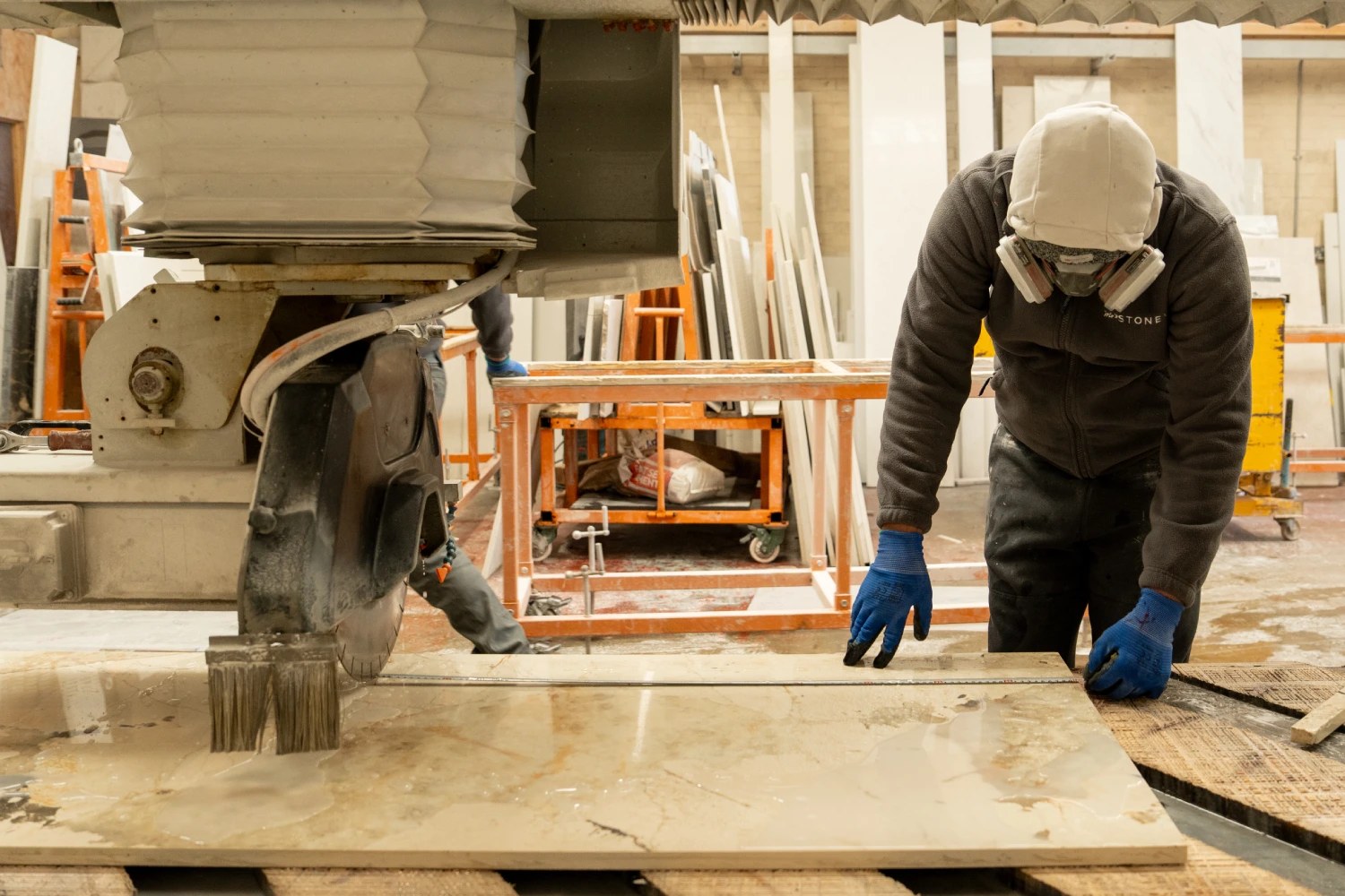 Stone slab being cut in a fabrication workshop